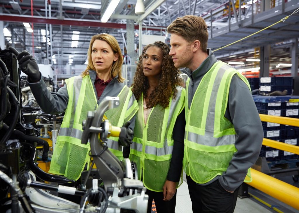 Two women and their male colleague working in the Canadian automotive industry