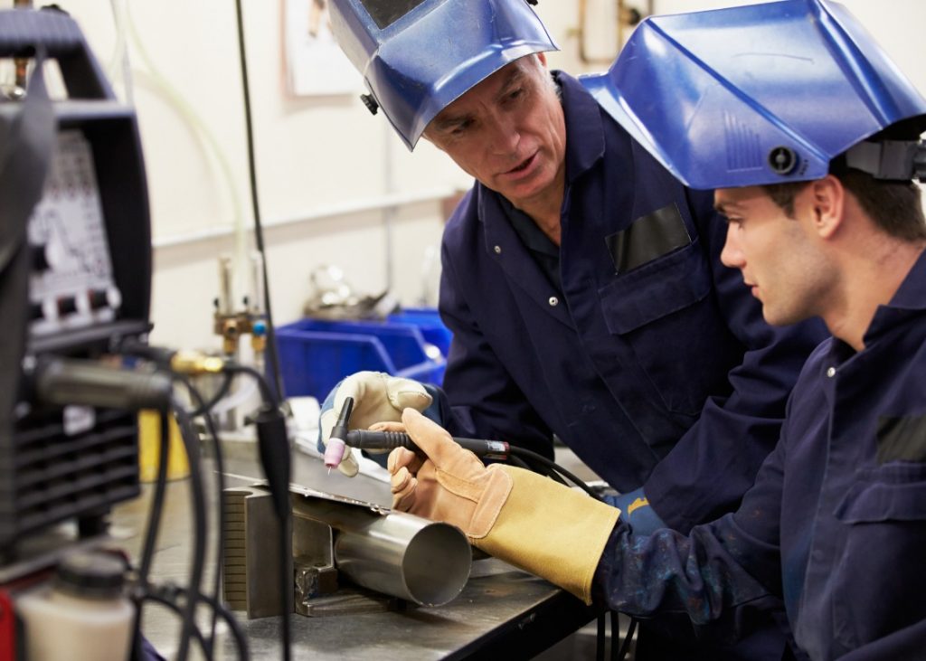 Youth apprentice working as a skilled labourer in Canada's automotive industry